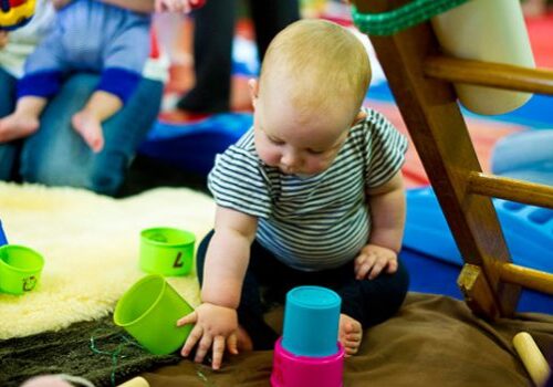 baby exploring sensory material