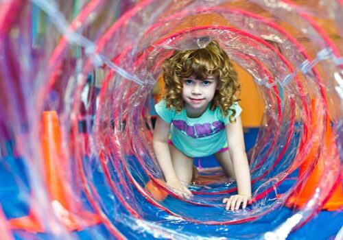 girl hiding in tunnel